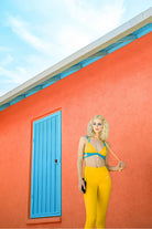 model wearing strap bikini top with yellow pants